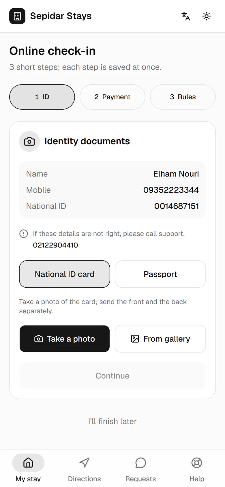 She checks her details and photographs her national ID card with the phone camera.
